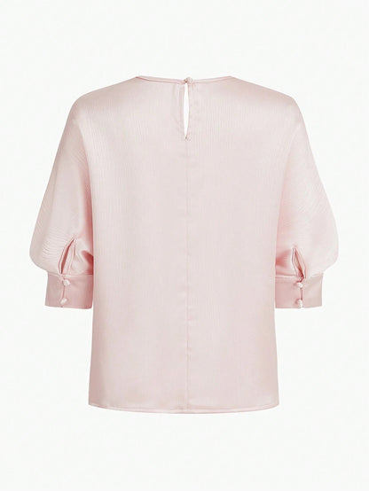 Blusa elegante de textura con orificio en la espalda